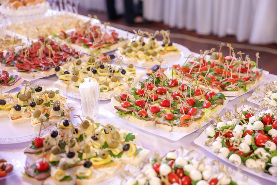 Assorted appetizers and finger foods at indoor event buffet