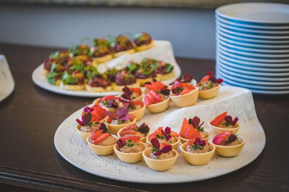 Elegant display of gourmet mini desserts with strawberries, perfect for upscale dining settings.